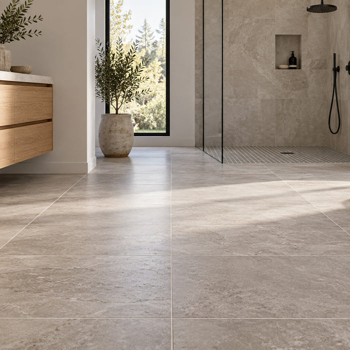 Modern bathroom with stone-look floor tiles, an oak vanity, and a walk-in shower.