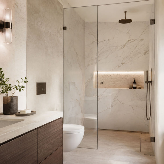 Bright small bathroom with light natural stone surfaces, marble shower walls, a stone vanity top, and a calm neutral layout that helps a compact bathroom feel larger.