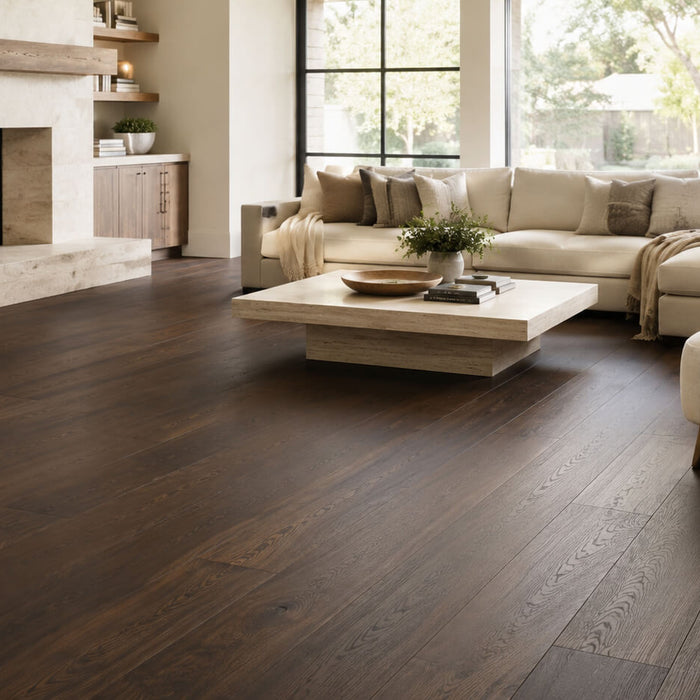 Bright modern living room with dark hardwood flooring, wide planks, a light sectional sofa, and a fireplace showing the rich contrast of dark wood floors.