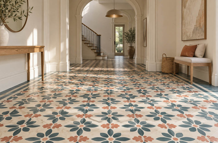 Sunlit hallway with teal and terracotta patterned encaustic tiles, classic arches and modern oak furniture.