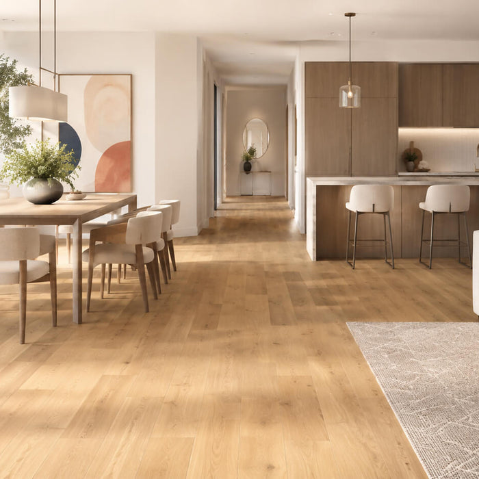 Bright modern open-plan interior with light engineered hardwood flooring in a living, dining, and kitchen space.