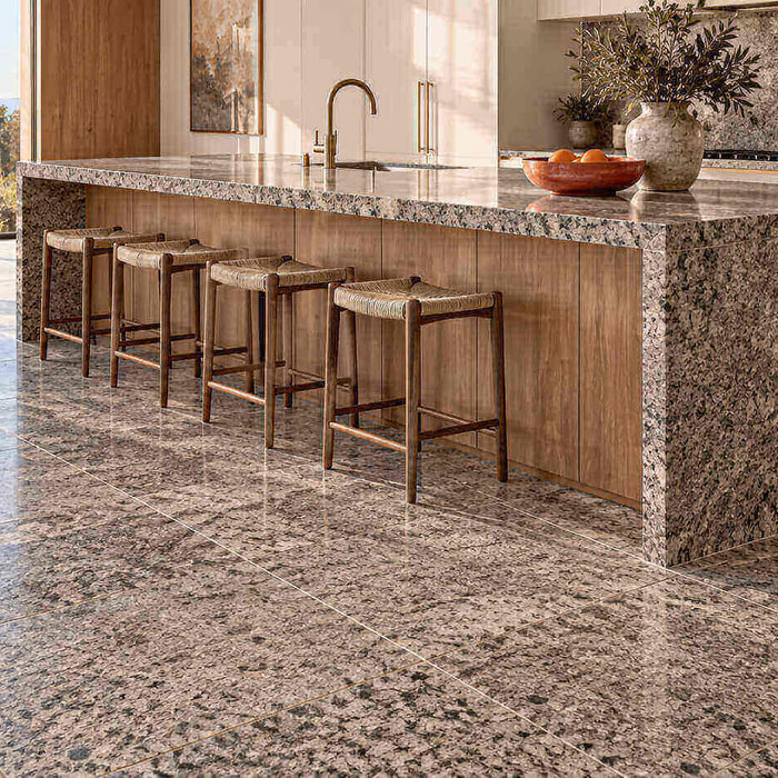 Modern kitchen with a granite tile floor, a granite slab waterfall island, and warm wood cabinetry.