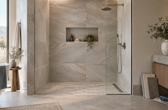 Modern tiled walk-in shower with large-format stone-look tiles, recessed niche, and linear drain
