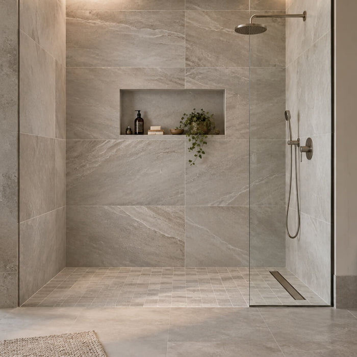 Modern tiled walk-in shower with large-format stone-look tiles, recessed niche, and linear drain