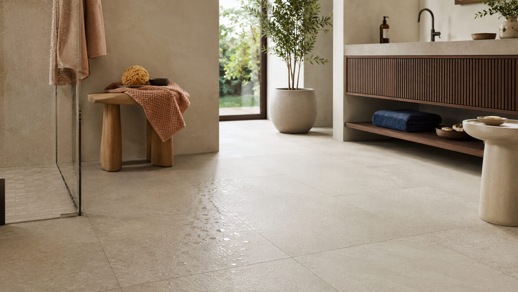Modern bathroom with light beige porcelain tile flooring and visible water droplets, illustrating wet-floor slip conditions for porcelain tile.