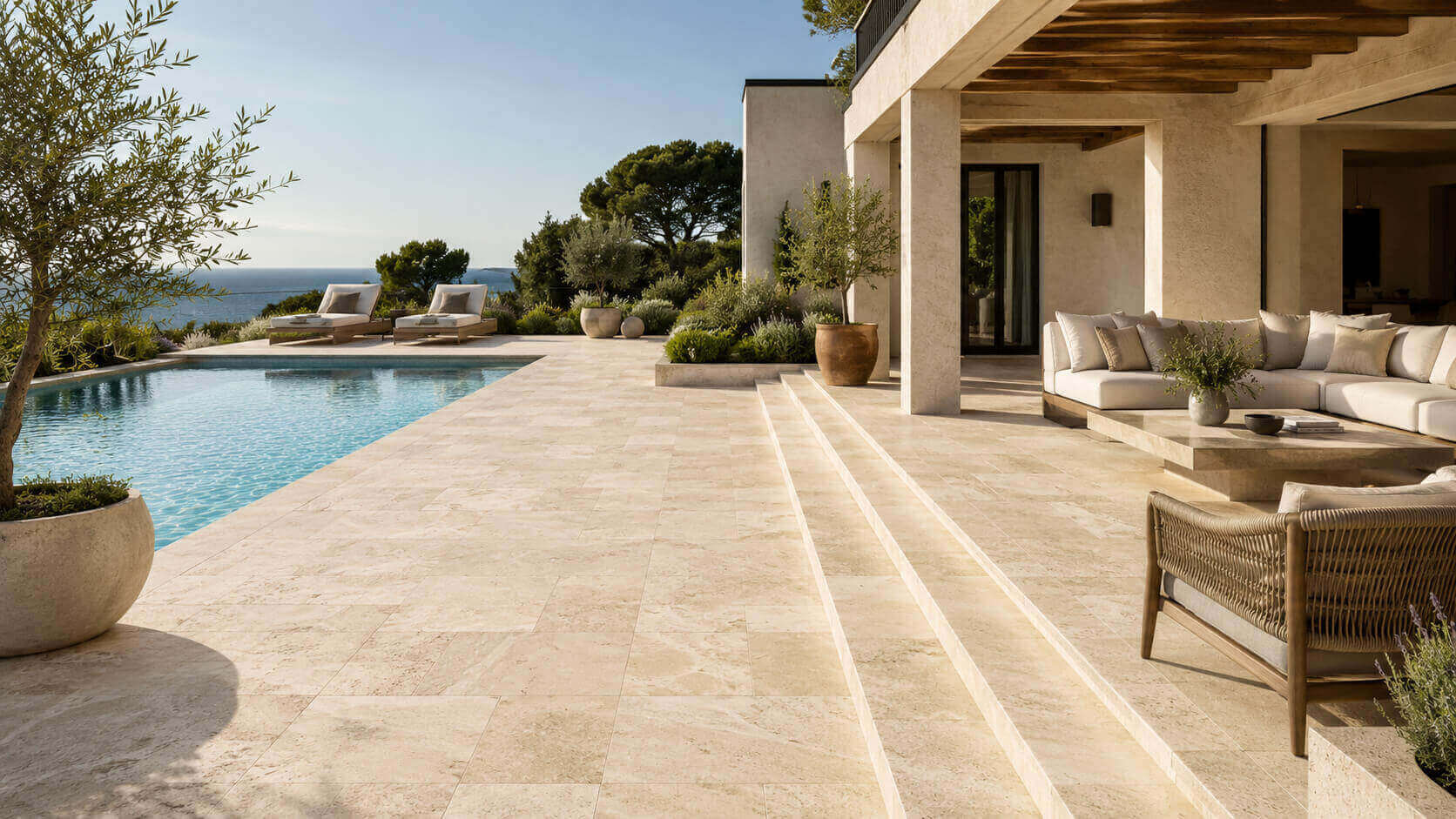 Ivory Travertine outdoor patio and pool deck with warm Mediterranean-inspired landscaping