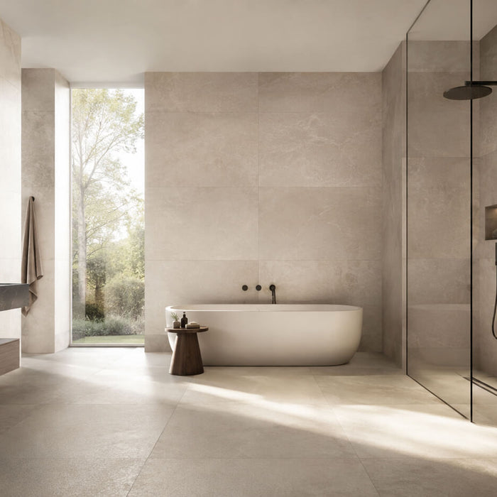 Modern bathroom with large-format beige porcelain tile on floors and walls, creating a seamless and minimal design.