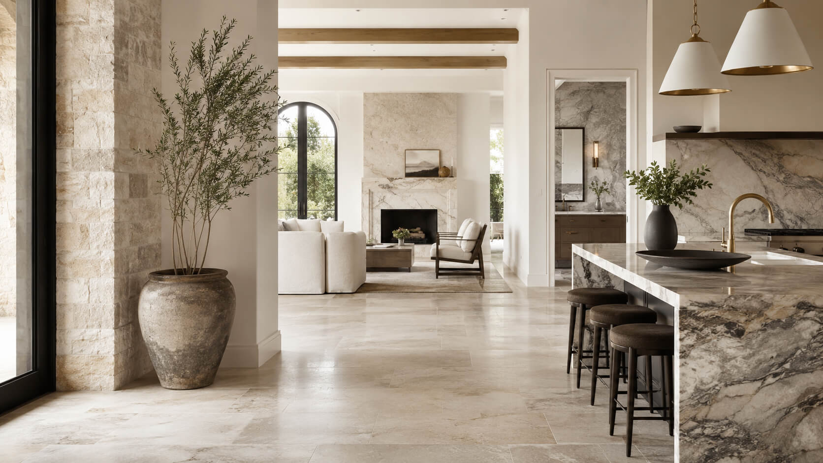 Luxury home renovation featuring natural stone flooring, marble kitchen surfaces, and a stone fireplace.