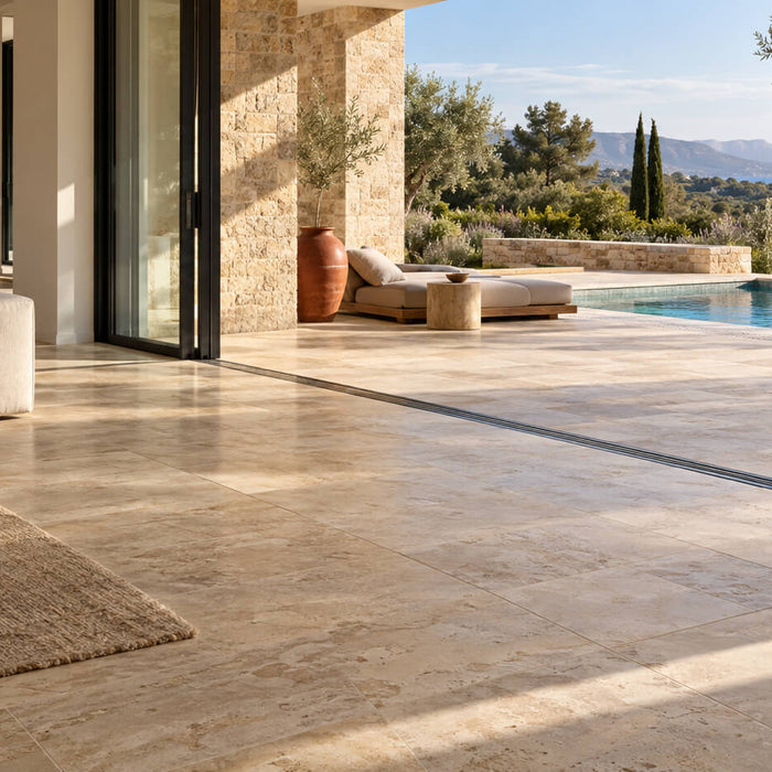 Luxury villa living room with beige travertine flooring opening onto a coordinated terrace and swimming pool.