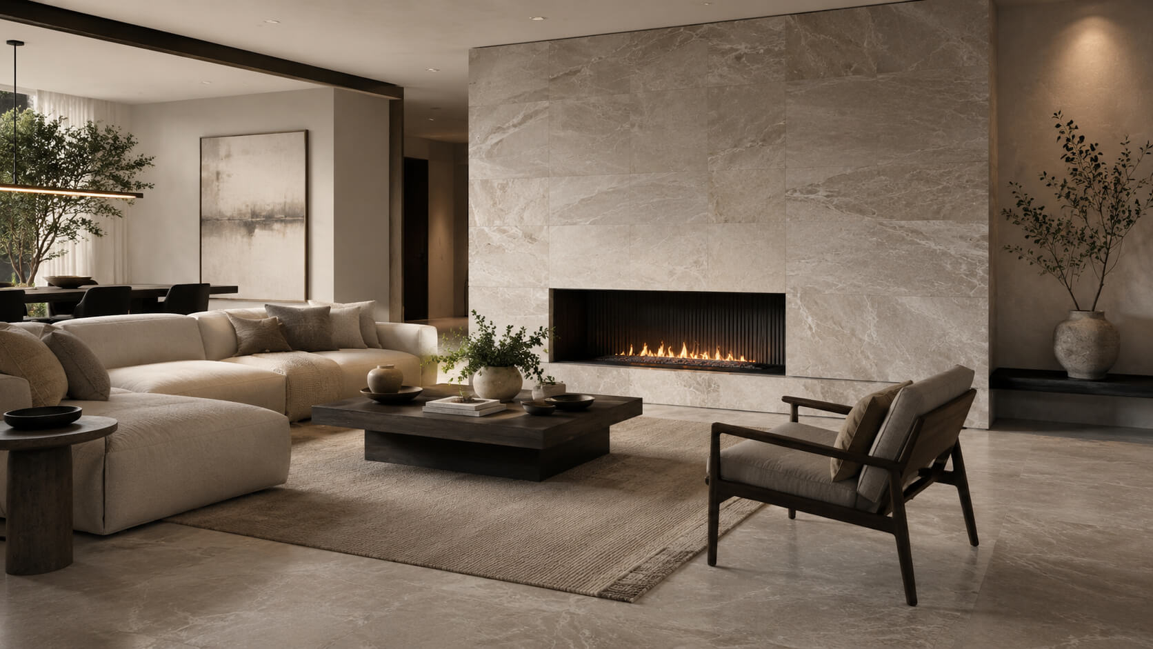 Modern monochrome living room with natural stone tile flooring and a large stone fireplace wall in warm neutral tones.