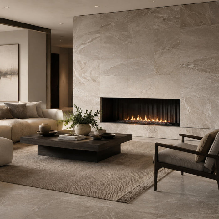 Modern monochrome living room with natural stone tile flooring and a large stone fireplace wall in warm neutral tones.
