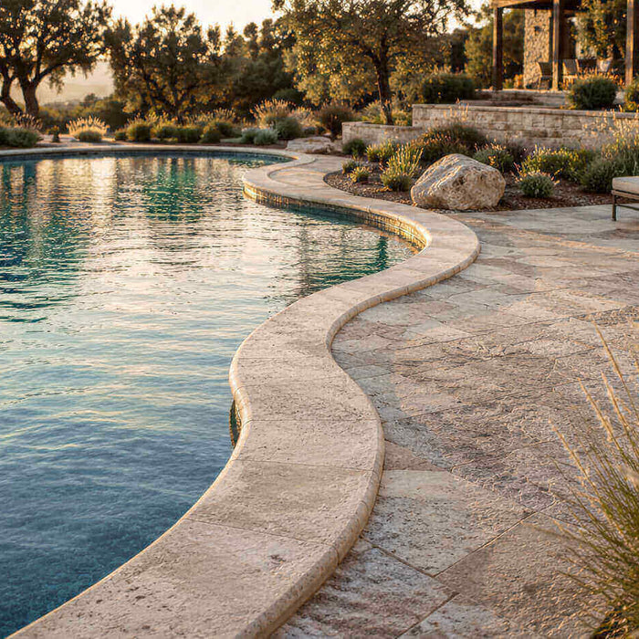 Freeform swimming pool with curved natural stone coping and coordinated stone pool deck