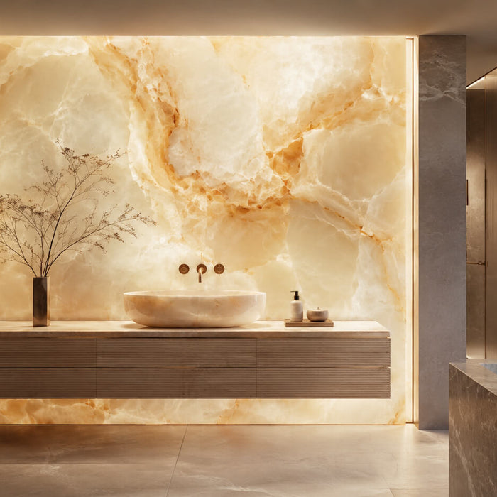 Luxury bathroom interior with a backlit onyx stone feature wall, floating vanity, vessel sink, and warm ambient lighting