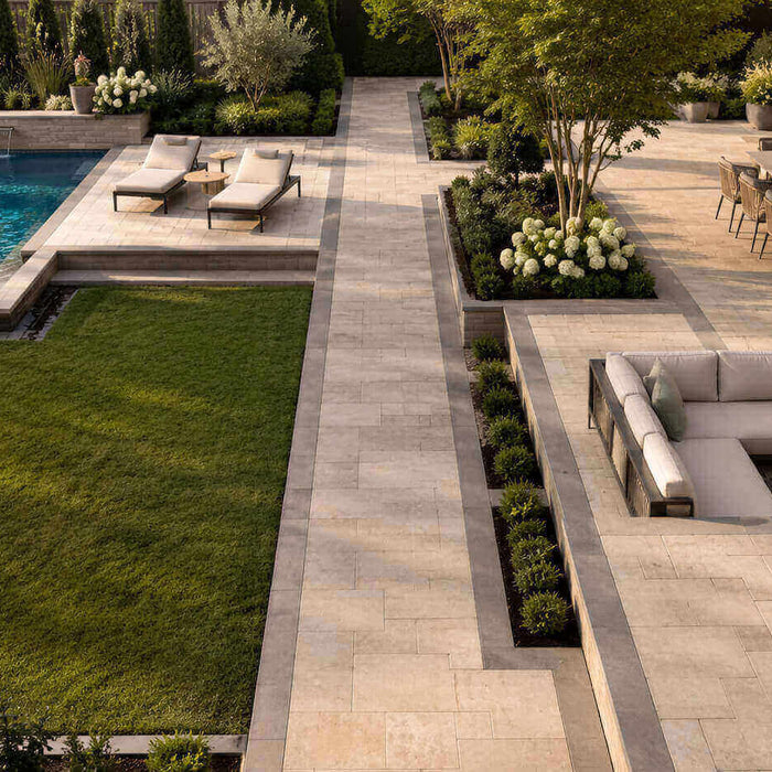 Modern backyard with paver borders defining the patio, pool deck, lawn, and walkways