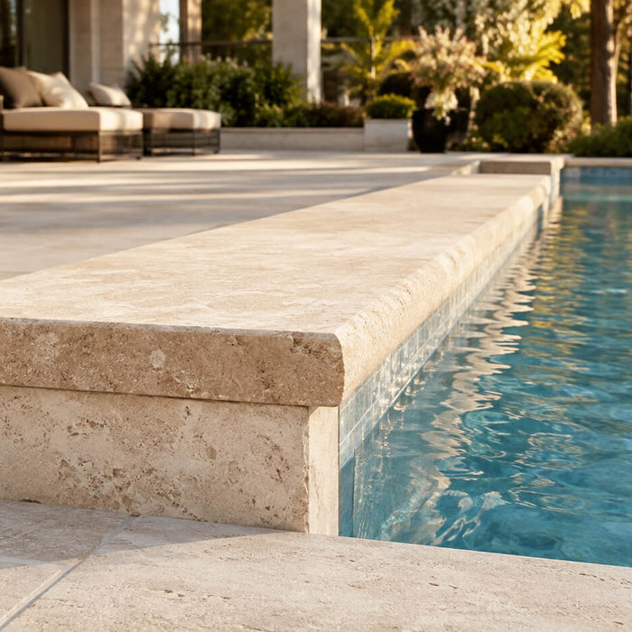 Natural stone pool coping with a thick rounded edge surrounding a luxury residential swimming pool