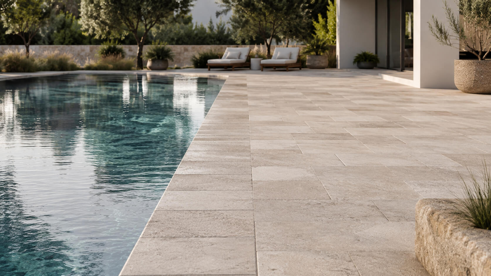 Luxury outdoor pool with light textured natural stone coping and deck, showing a safe and elegant poolside surface in a modern residential setting.