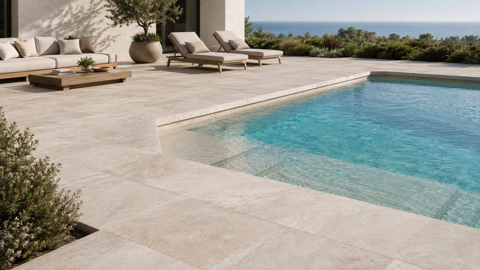 Light beige travertine pool deck around a modern outdoor pool with lounge seating and a natural resort-style patio