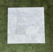 Close-up of Tundra Marble Leather (Sandblasted & Brushed) French Versailles x 1/2 Tile, in Tundra tones.