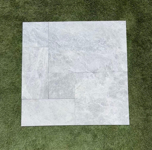 Close-up of Tundra Marble Leather (Sandblasted & Brushed) French Versailles x 1/2 Tile, in Tundra tones.