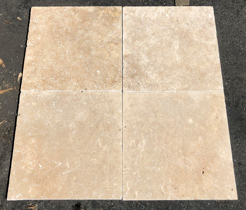 Close-up of Ivory Cordoba Cream Travertine Tumbled 12 x 12 x 3/8 Cross Cut Tile, in Ivory tones.