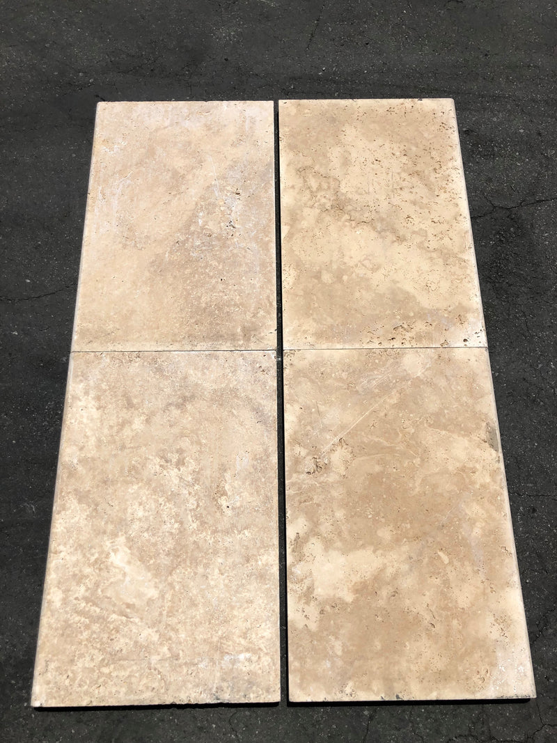 Close-up of Ivory Cordoba Cream Travertine Tumbled 16 x 24 x 1/2 Cross Cut Tile, in Ivory tones.