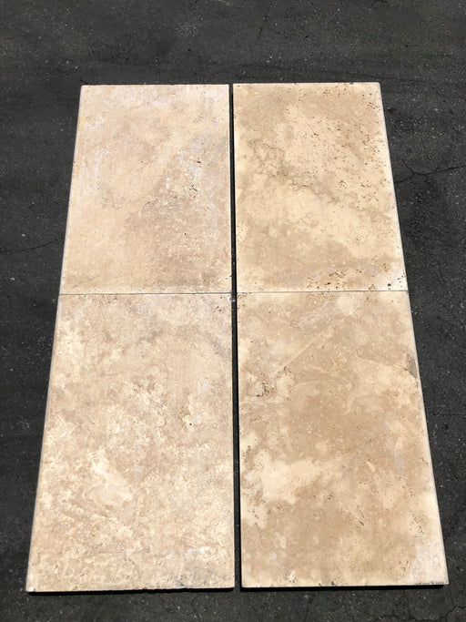 Close-up of Ivory Cordoba Cream Travertine Tumbled 16 x 24 x 1/2 Cross Cut Tile, in Ivory tones.