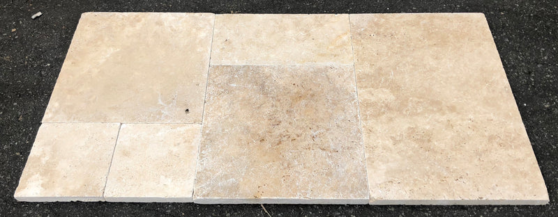 Close-up of Ivory Cordoba Cream Travertine Tumbled French Versailles x 1/2 Cross Cut Tile, in Ivory tones.