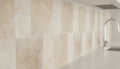 Close-up of Ivory Cordoba Cream Travertine Tumbled French Versailles x 1/2 Cross Cut Tile, in Ivory tones.