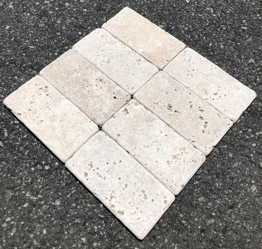 Close-up of Ivory Cordoba Cream Travertine Tumbled 3 x 6 x 3/8 Cross Cut Tile, in Ivory tones.