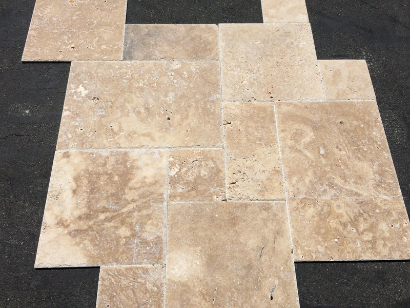 Close-up of Chocolate Brown Walnut Travertine Unfilled, Brushed & Chiseled French Versailles x 1/2 Cross Cut Tile, in Brown tones.