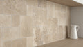 Close-up of Noce Travertine Unfilled, Brushed & Chiseled French Versailles x 1/2 Cross Cut Tile, in Noce tones.