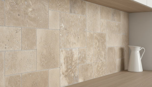 Close-up of Noce Travertine Unfilled, Brushed & Chiseled French Versailles x 1/2 Cross Cut Tile, in Noce tones.