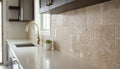 Close-up of Noce Travertine Tumbled French Versailles x 1/2 Cross Cut Tile, in Noce tones.
