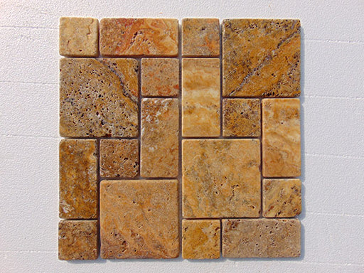 Close-up of Autumn Leaves Scabos Travertine Unfilled, Brushed & Chiseled French Versailles x 1/2 Cross Cut Tile, in Autumn tones.