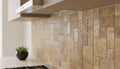Close-up of Autumn Leaves Scabos Travertine Unfilled, Brushed & Chiseled French Versailles x 1/2 Cross Cut Tile, in Autumn tones.