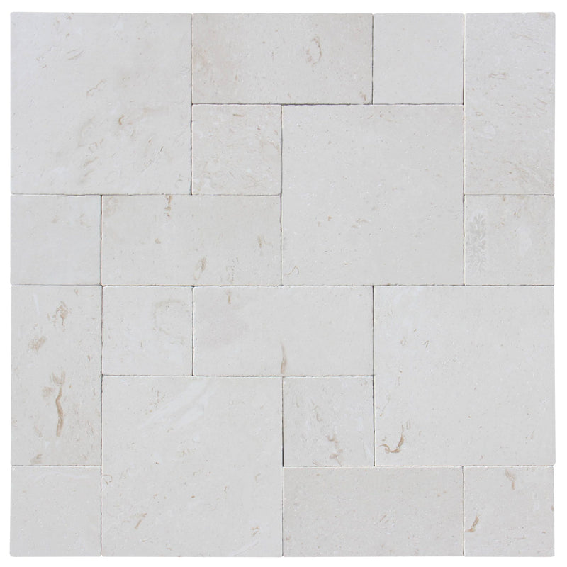 Close-up of Desert Sand Limestone Unfilled, Brushed & Chiseled French Versailles x 1/2 Cross Cut Tile, in Desert Sand tones.
