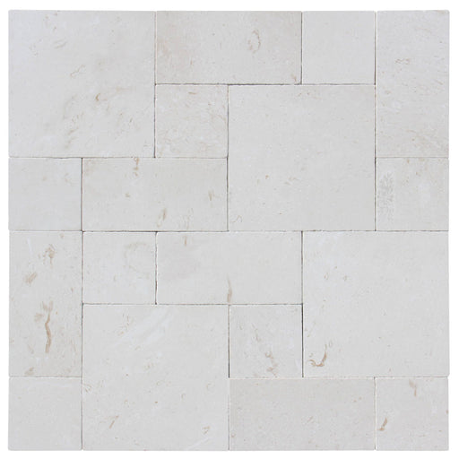 Close-up of Desert Sand Limestone Unfilled, Brushed & Chiseled French Versailles x 1/2 Cross Cut Tile, in Desert Sand tones.
