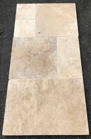 Close-up of Ivory Cordoba Cream Travertine Tumbled French Versailles x 1.25 Paver, in Ivory tones.
