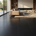 Absolute Black 18x18 Honed Granite Tile flooring in a contemporary living room with a beige sofa, fireplace and large windows.