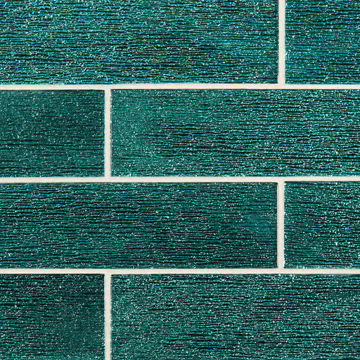 Anacapri 3x12 teal glass tile with horizontal textured ridges in a staggered brick pattern.