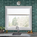 Anacapri 3x12 teal glass tile kitchen backsplash in a staggered brick pattern around a white-framed window above the sink.