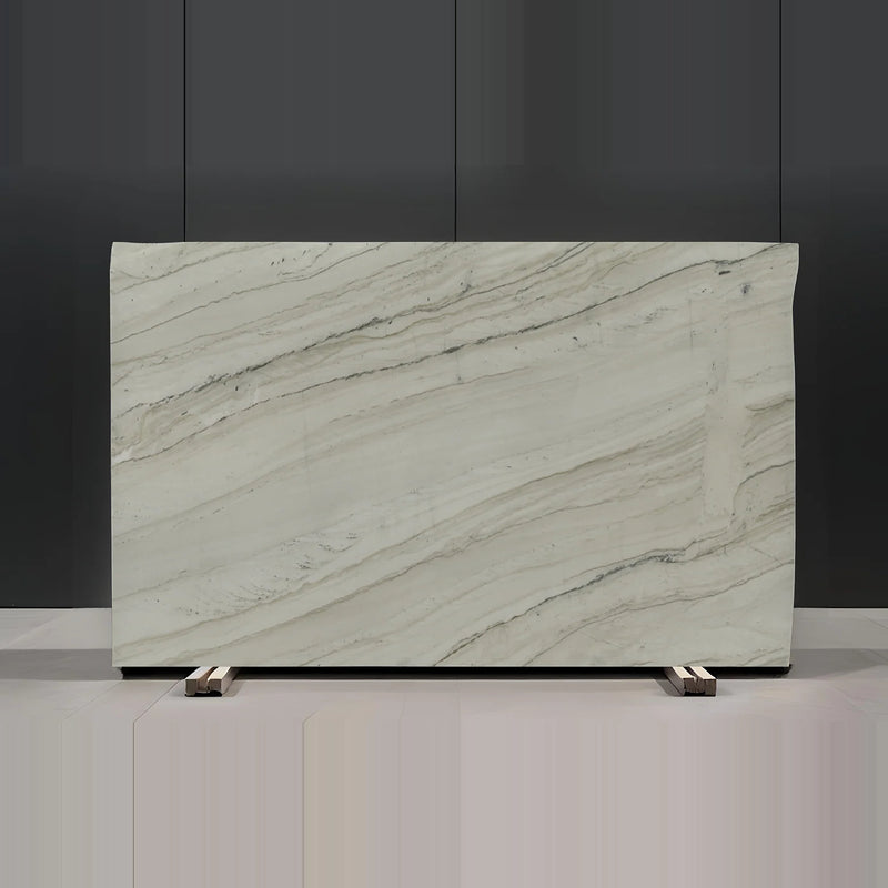 Full view of a Bellagio 3cm polished quartzite slab with a warm white surface, fine diagonal gray and beige veining, and a few darker mineral lines.