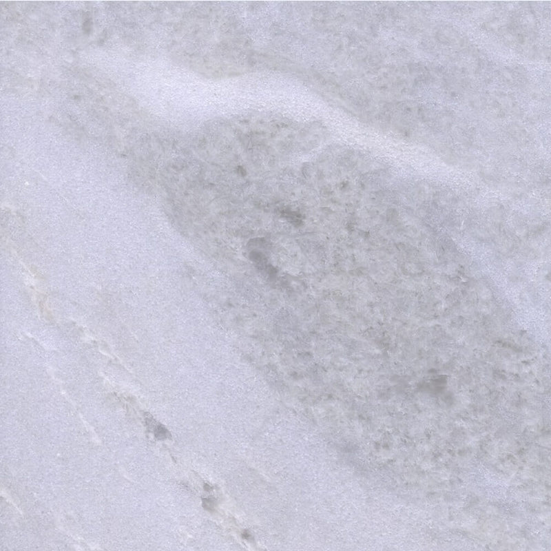 Close-up of Bianco Rhino Extra marble with soft white and gray cloud-like veining.