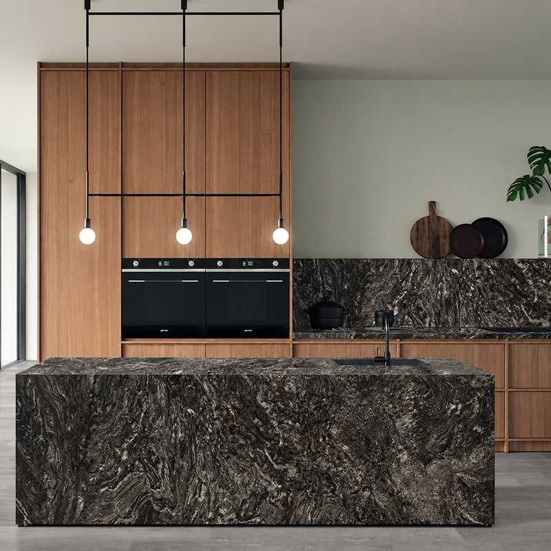 Black Forest 2cm granite on a kitchen island and backsplash, with flowing pale veins against a dark background.