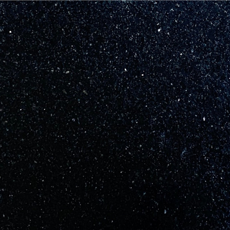 Close-up of Black Galaxy granite tile with a deep black surface and scattered reflective mineral flecks.