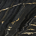 Black Taurus 2cm polished granite slab with a charcoal-black background and flowing gold and ivory veins.