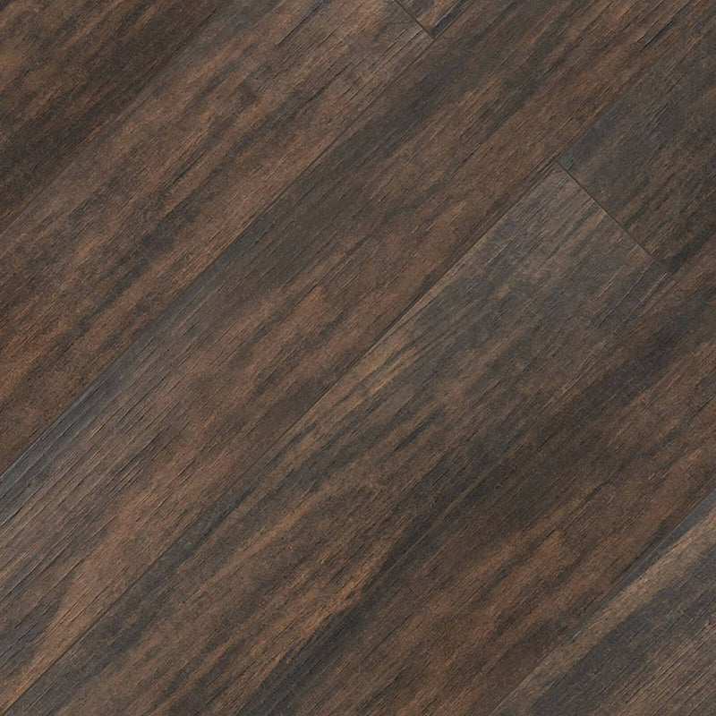 Botanica Teak 6x36 matte porcelain wood look tile with dark brown tones and diagonal wood grain across a staggered plank layout.