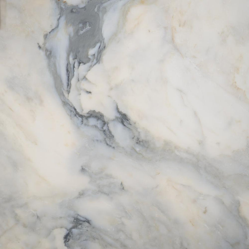 Calacatta Apuano 2cm honed marble slab with a creamy white background, flowing gray veins and subtle golden accents.