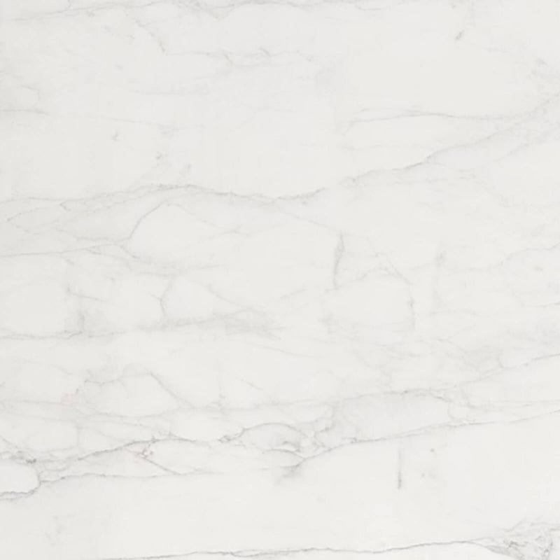 Calacatta Caldia 2cm honed marble slab close-up with a warm white background and subtle branching pale gray veins.