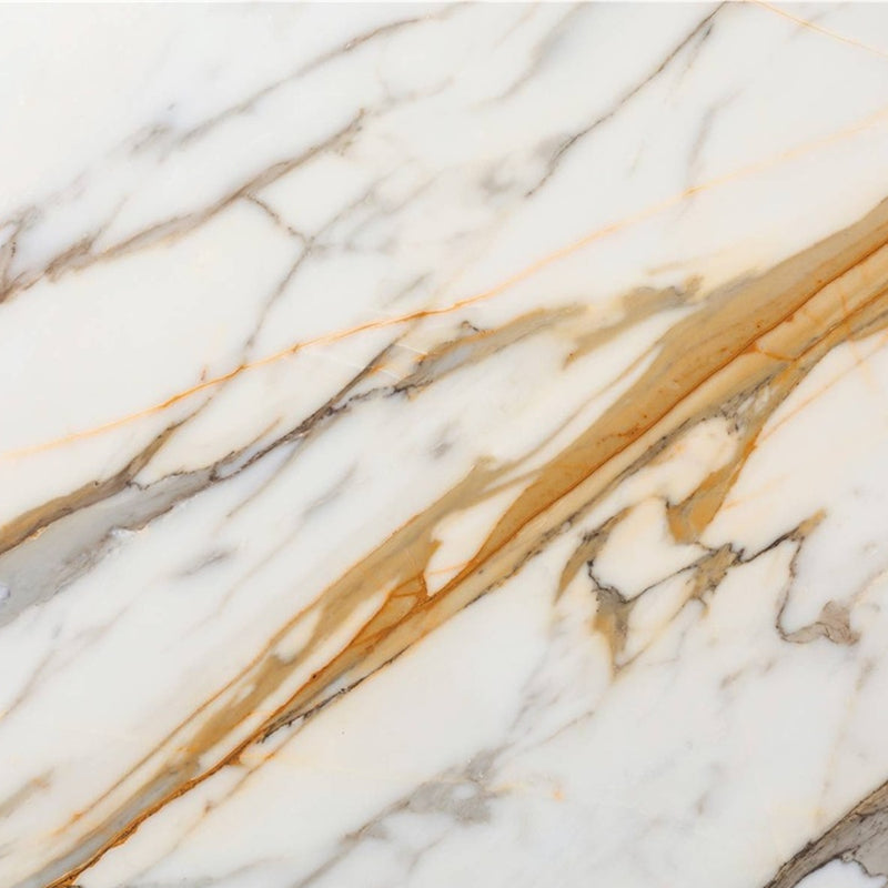 Calacatta Cremo marble with a white background and flowing gold and gray veins.